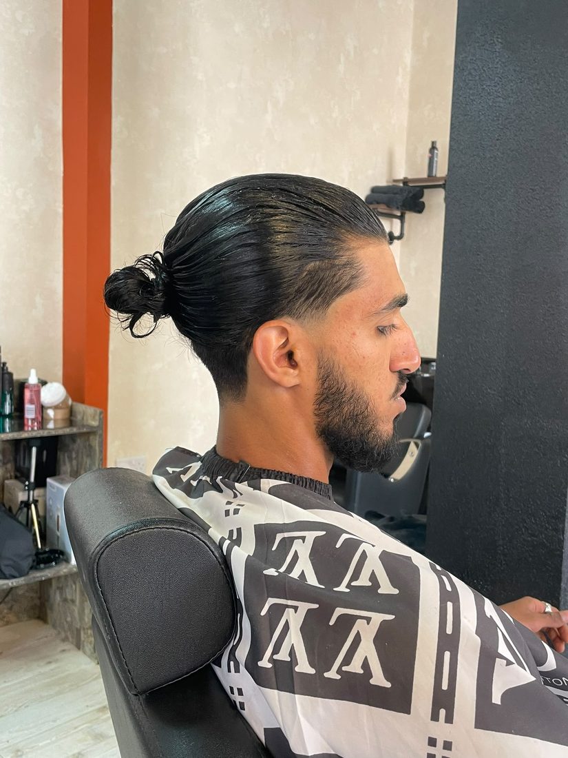 Top knot with slicked undercut
