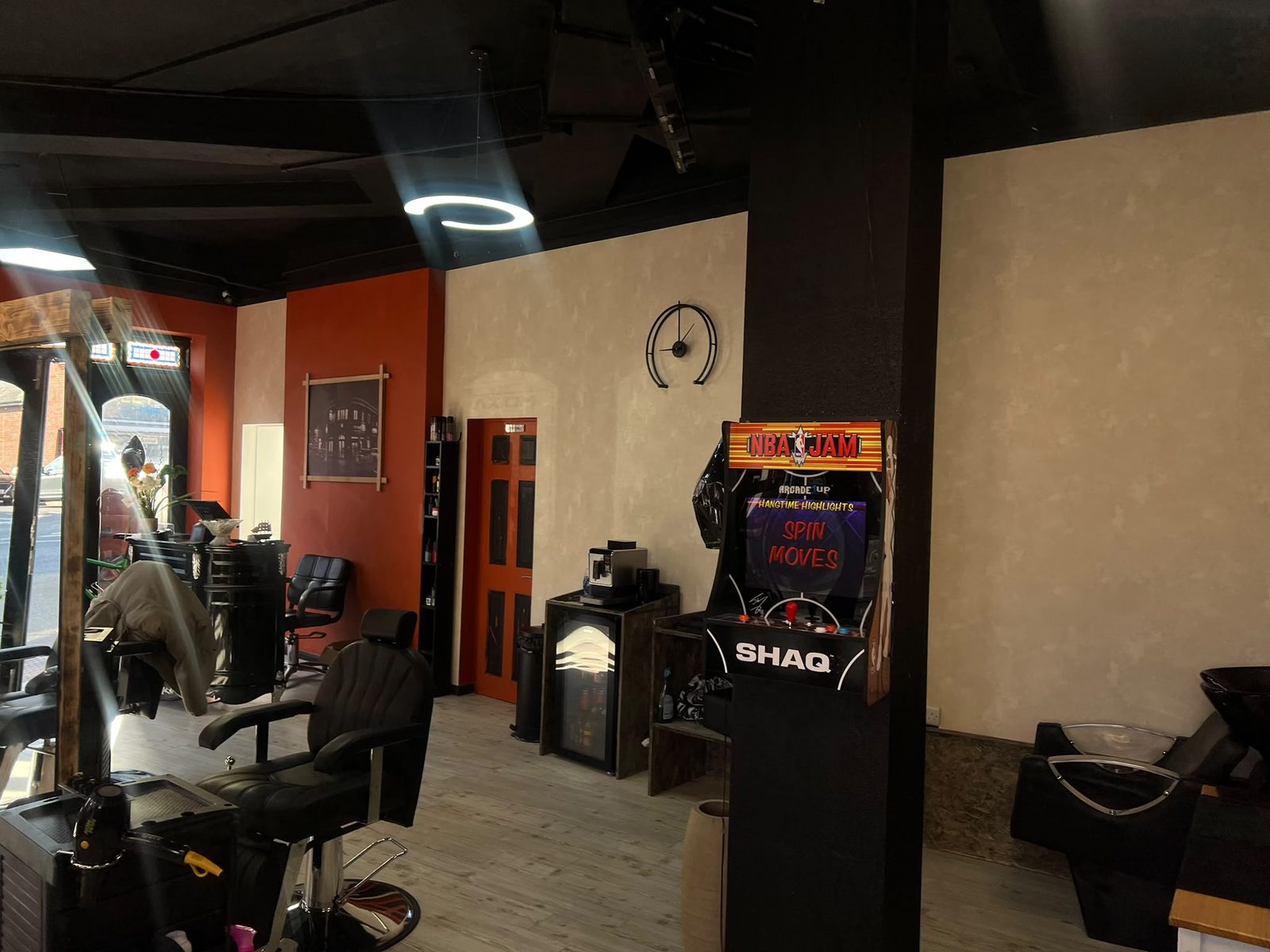 Inside Axiom — exposed beams, terracotta walls and an NBA Jam arcade machine